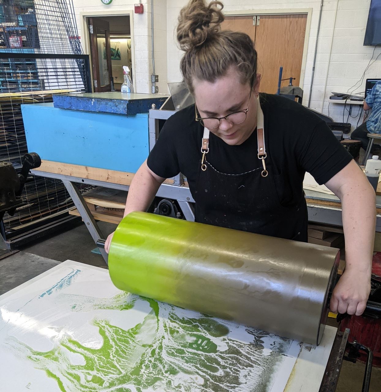 Instructor Kath Yarkosky inking up a photo litho plate using a large roller
