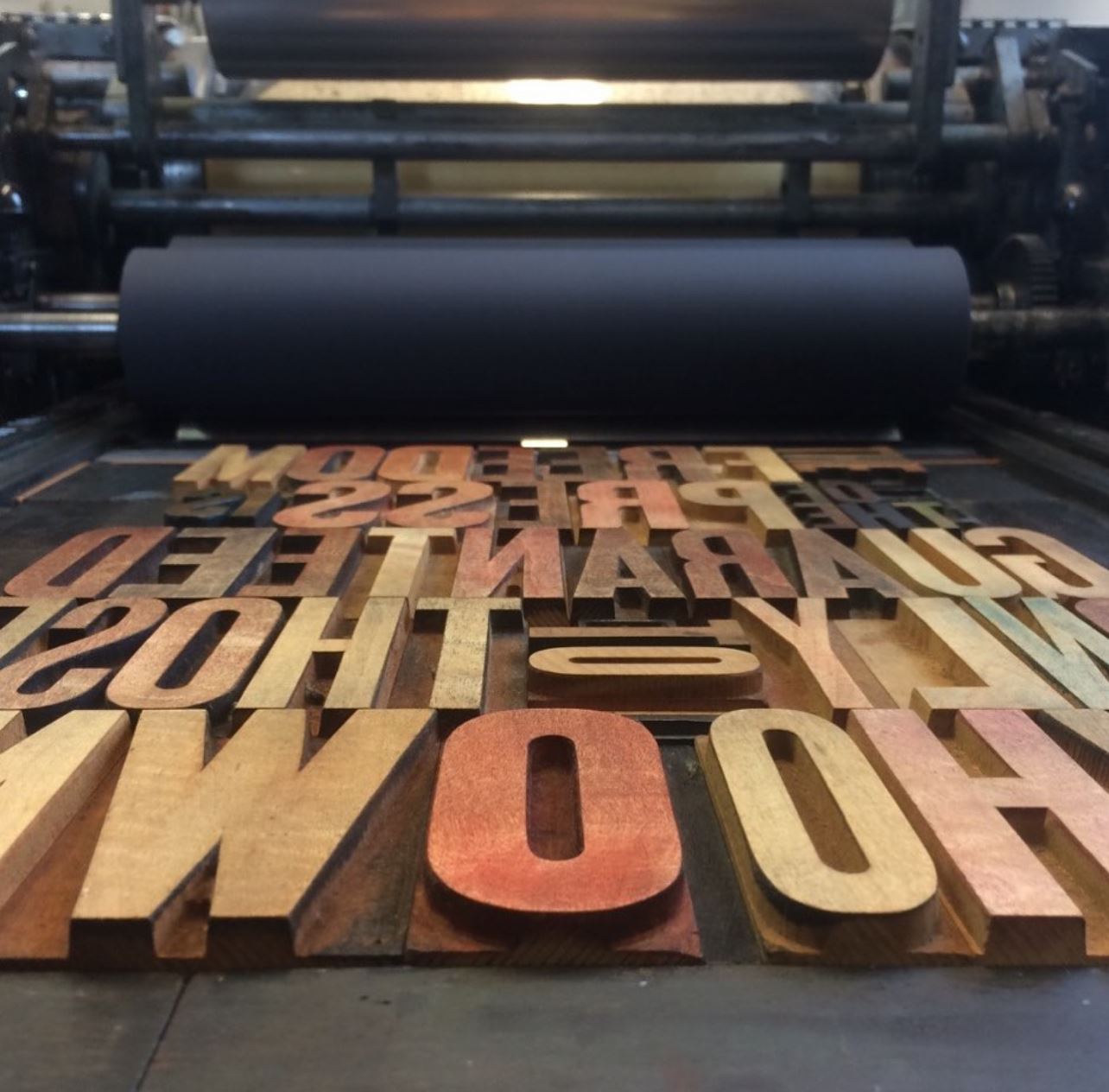 Close up of wood type locked up on a cylindrical press.