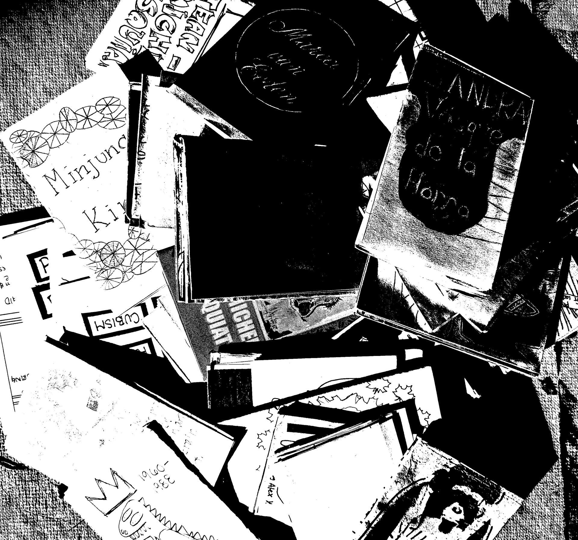 Black and white photo of a pile of zines.